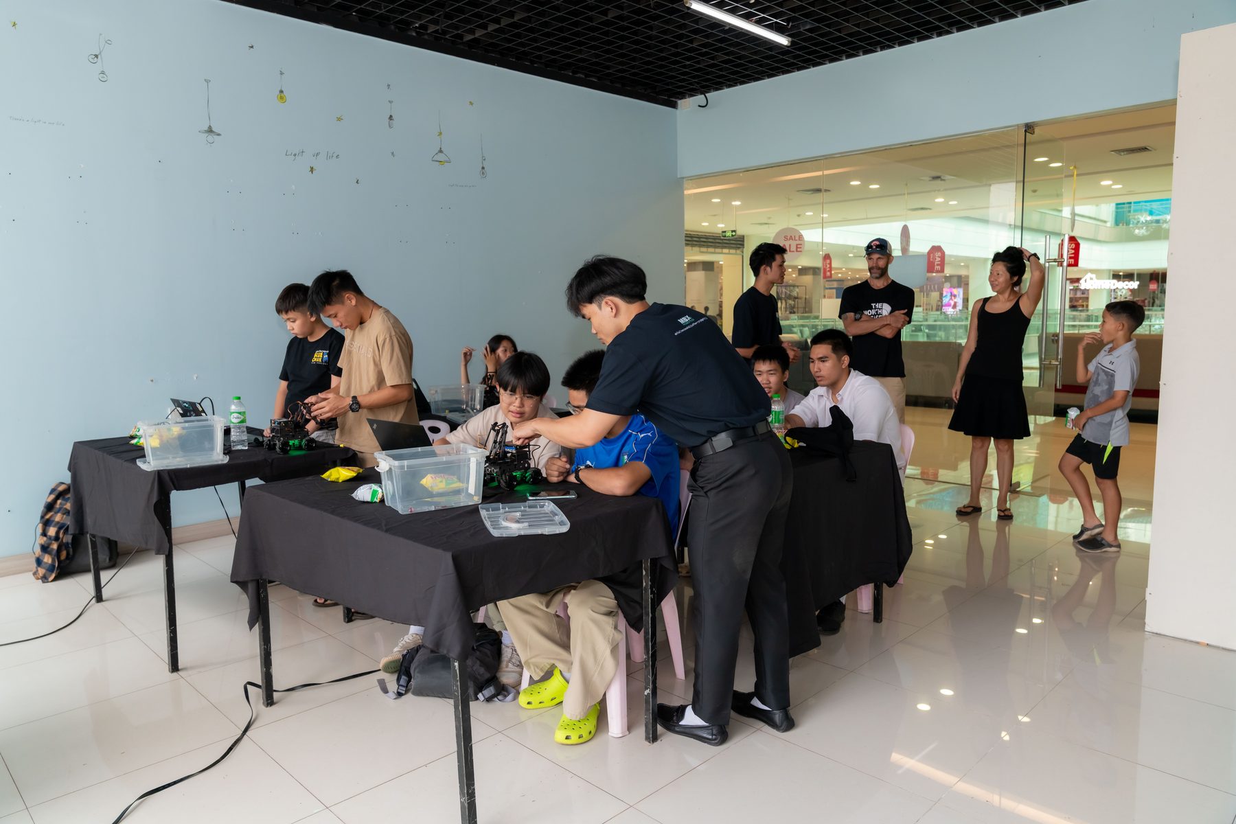 MBX Robotics team running a public robotics demo event at a shopping mall